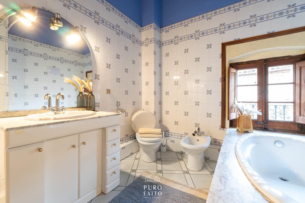 Bathroom with blue tiling and bath