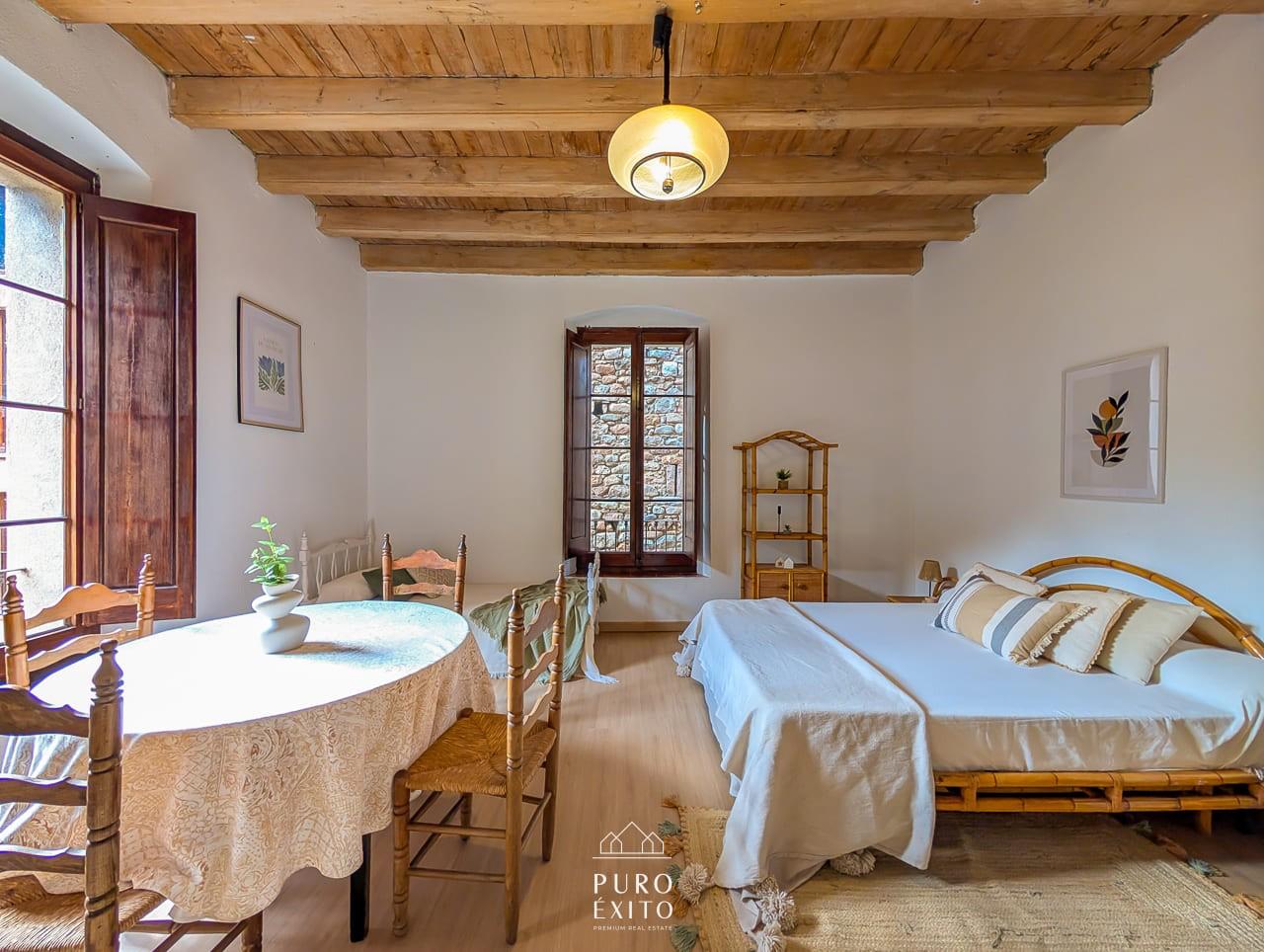 Large bedroom with cane bed and round table